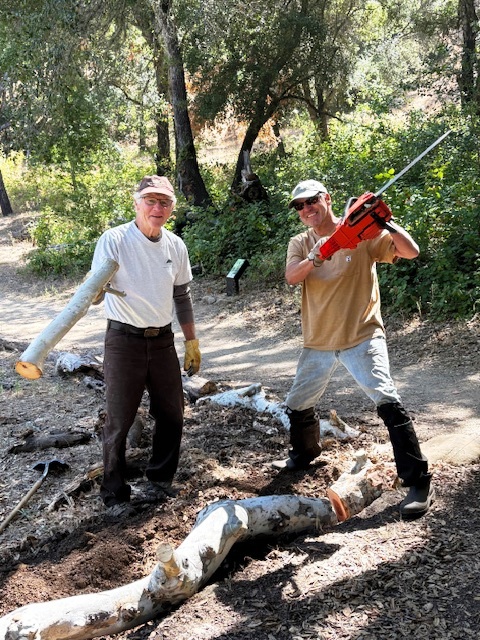 Bruce and Tim laying a sycamore branch along the path